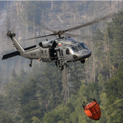A Sikorsky S-70i Black Hawk in Poland carries an SEI Industries bambi bucket through the forest. From Instagram user aviationspotter_1992